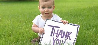 baby holding a thank you sign
